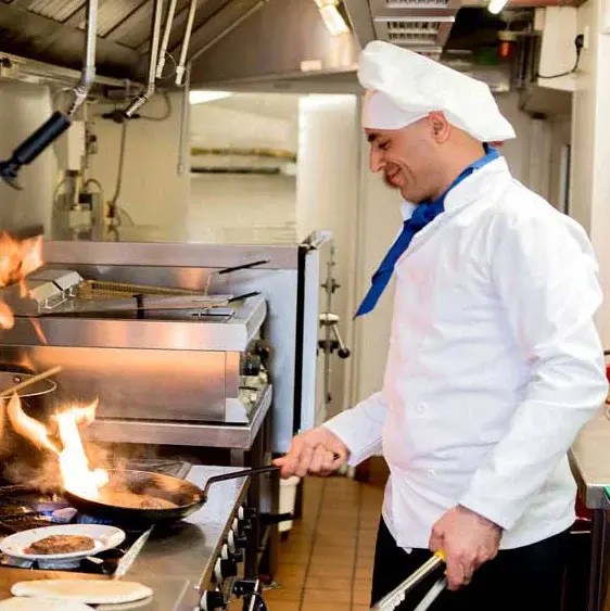 Steeplechase Chef Created Meals, chef frying a dish.
