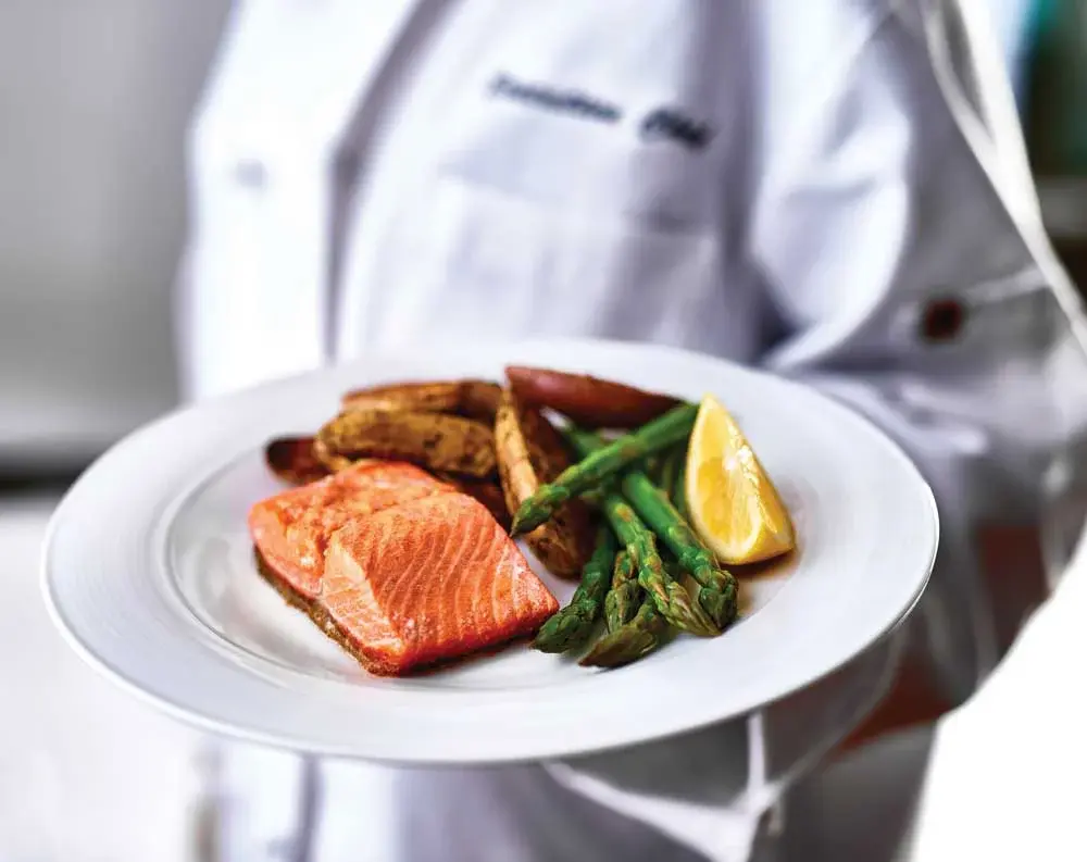 Steeplechase Chef Created Meals, chef delivering a finished dish.