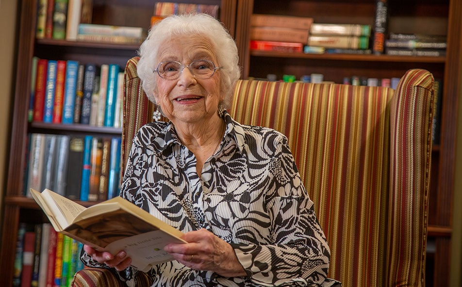 The library at Steeplechase with shelves of books and comfortable seating